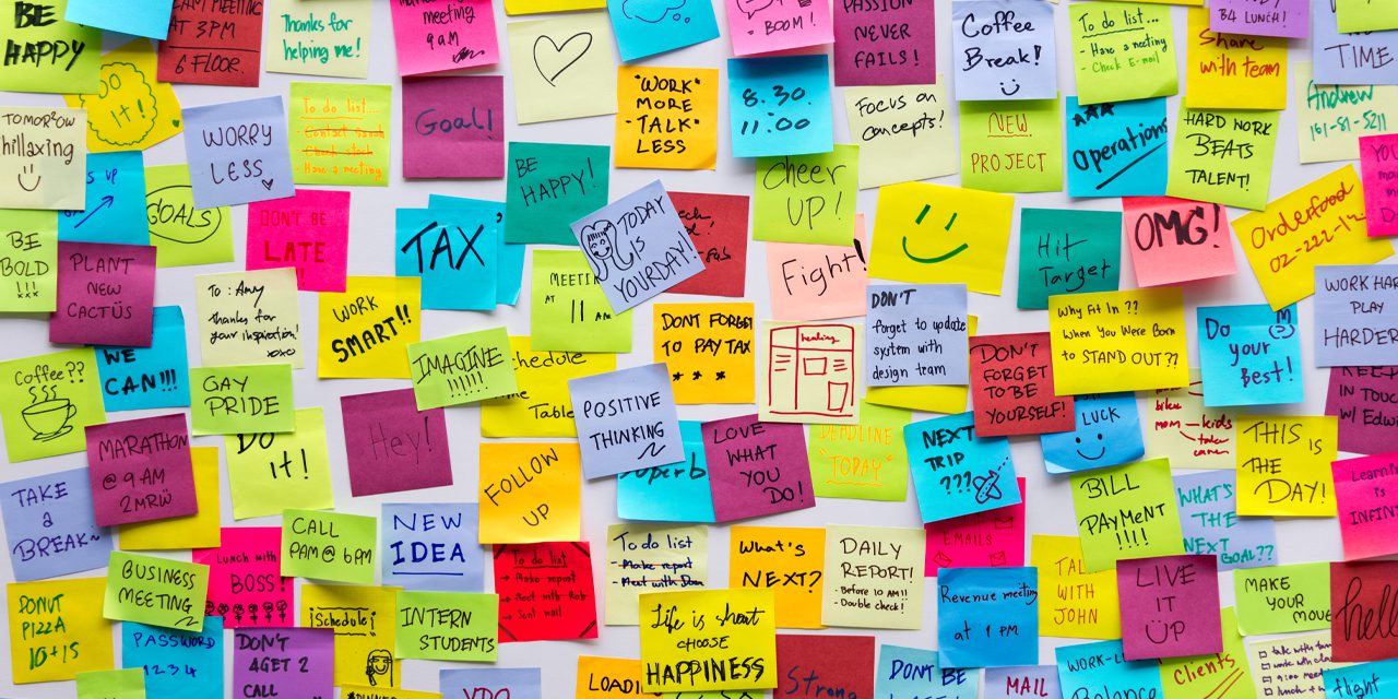 lots of sticky notes on a wall 