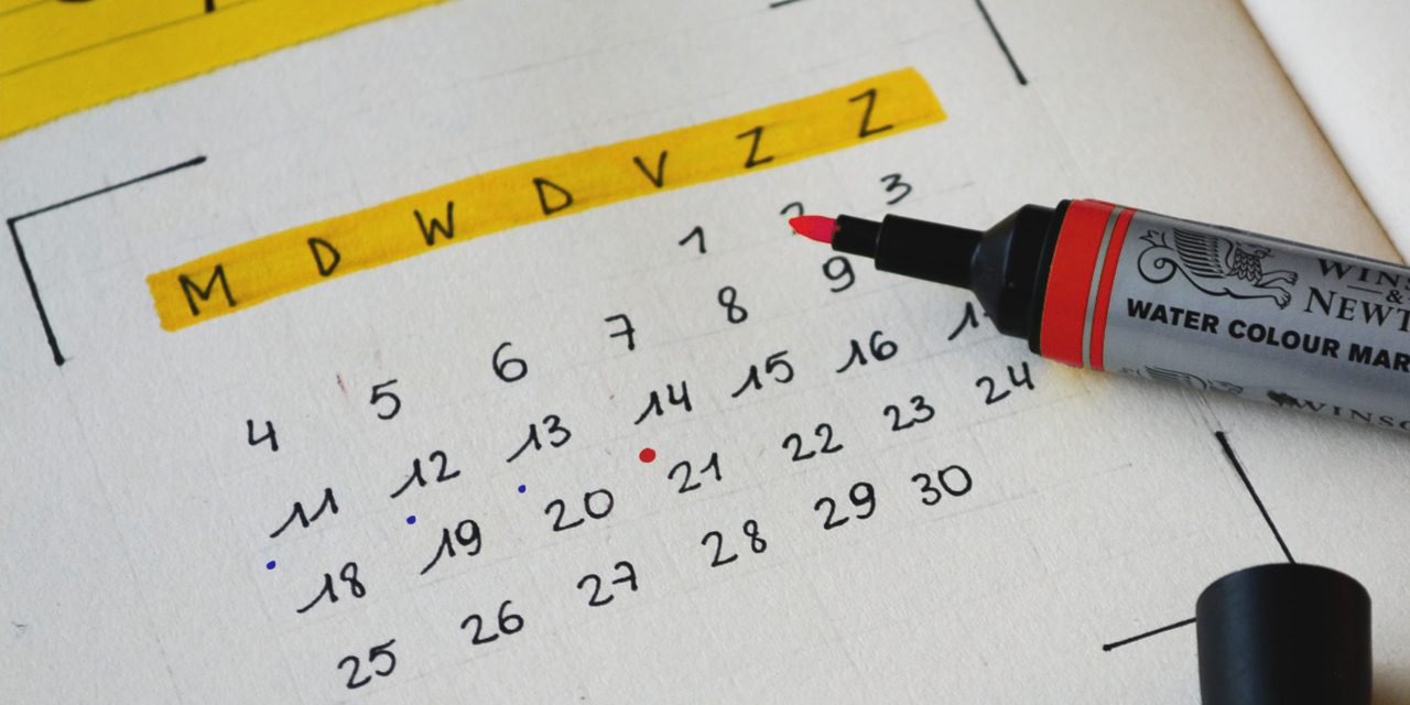 calendar in a notebook and pen