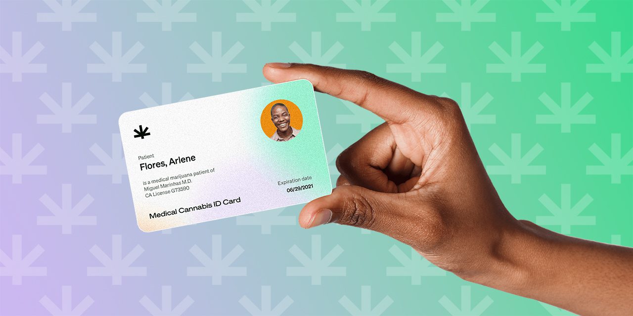 closeup hand holding a Leafwell's medical marijuana card
