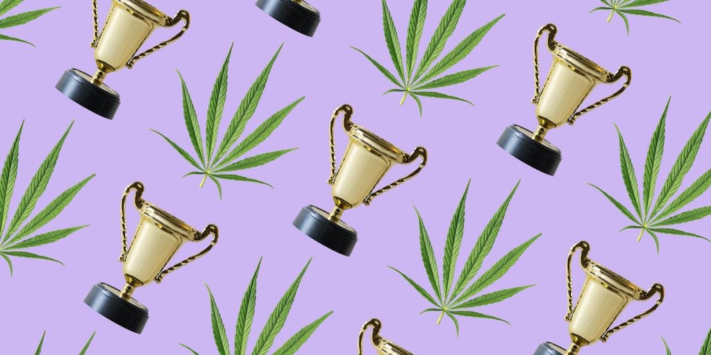 sativa leaf and trophy on a purple background