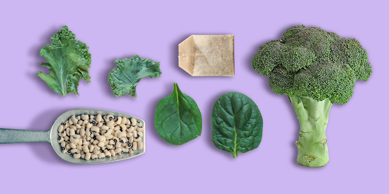 various vegetables - a cut of cabbage and spinach leaf, a scoop of beans, broccoli and a seed packet