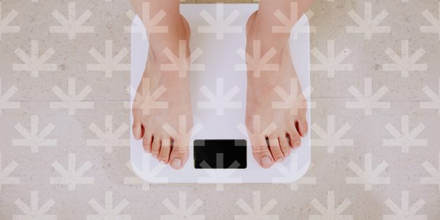 closeup pair of feet on a digital weighing scale