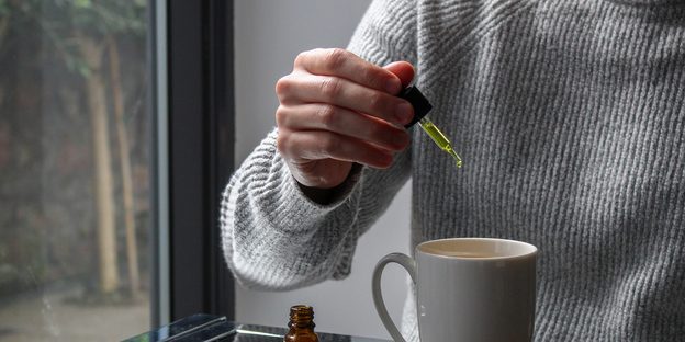 pouring CBD oil into drinks like coffee