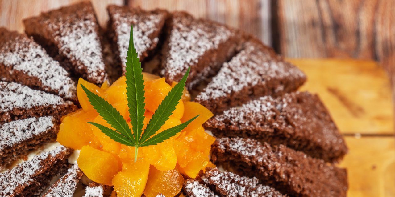 a cake with marijuana leaf on top