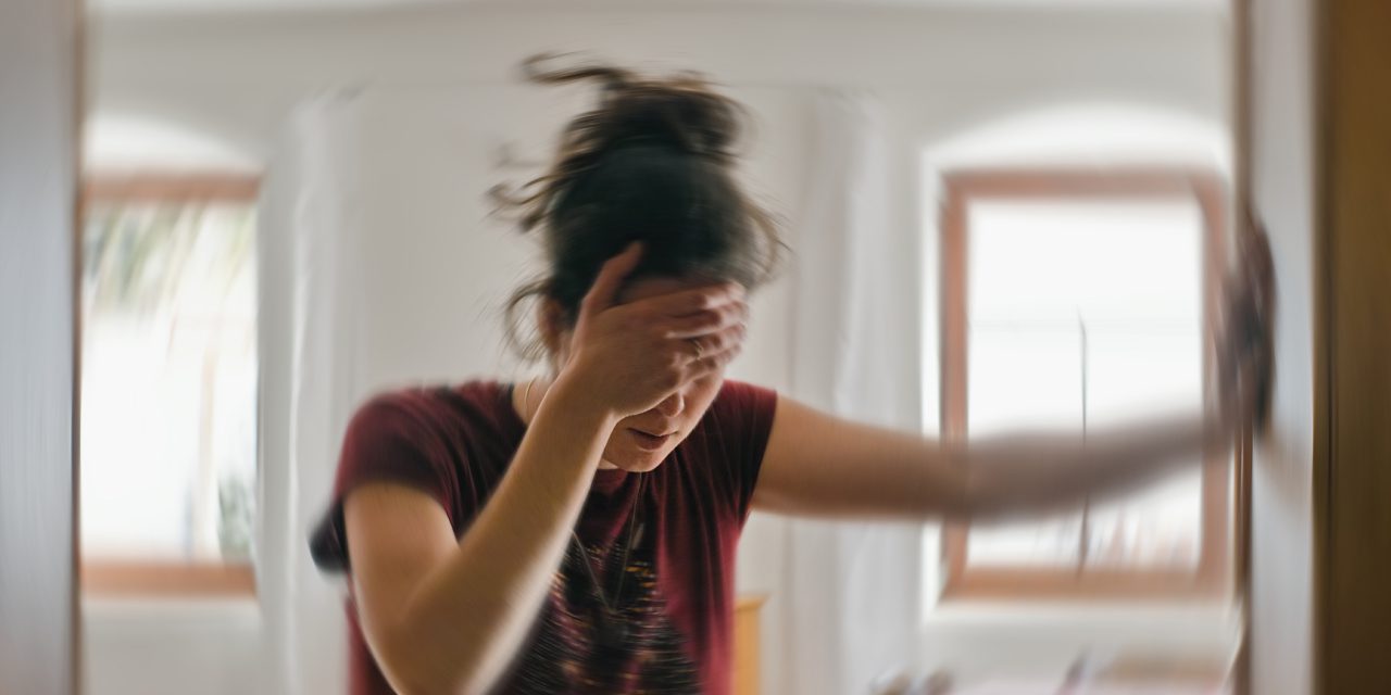 blurred photo of woman suffering from dizziness or other health problem