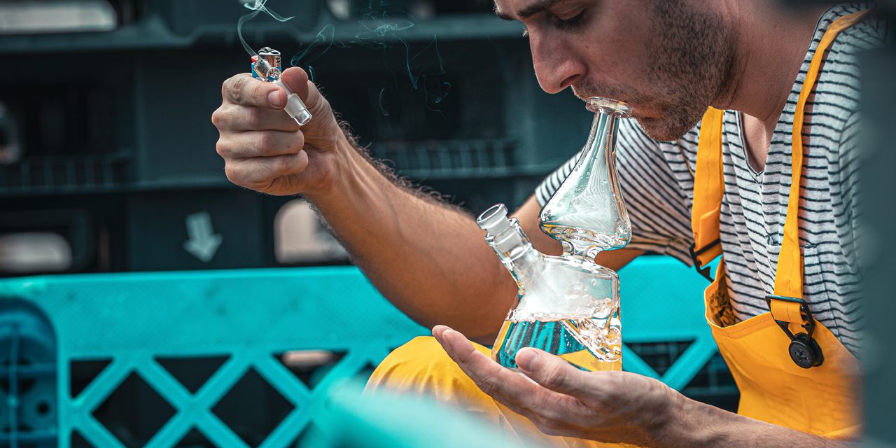 man smoking marijuana using bongs