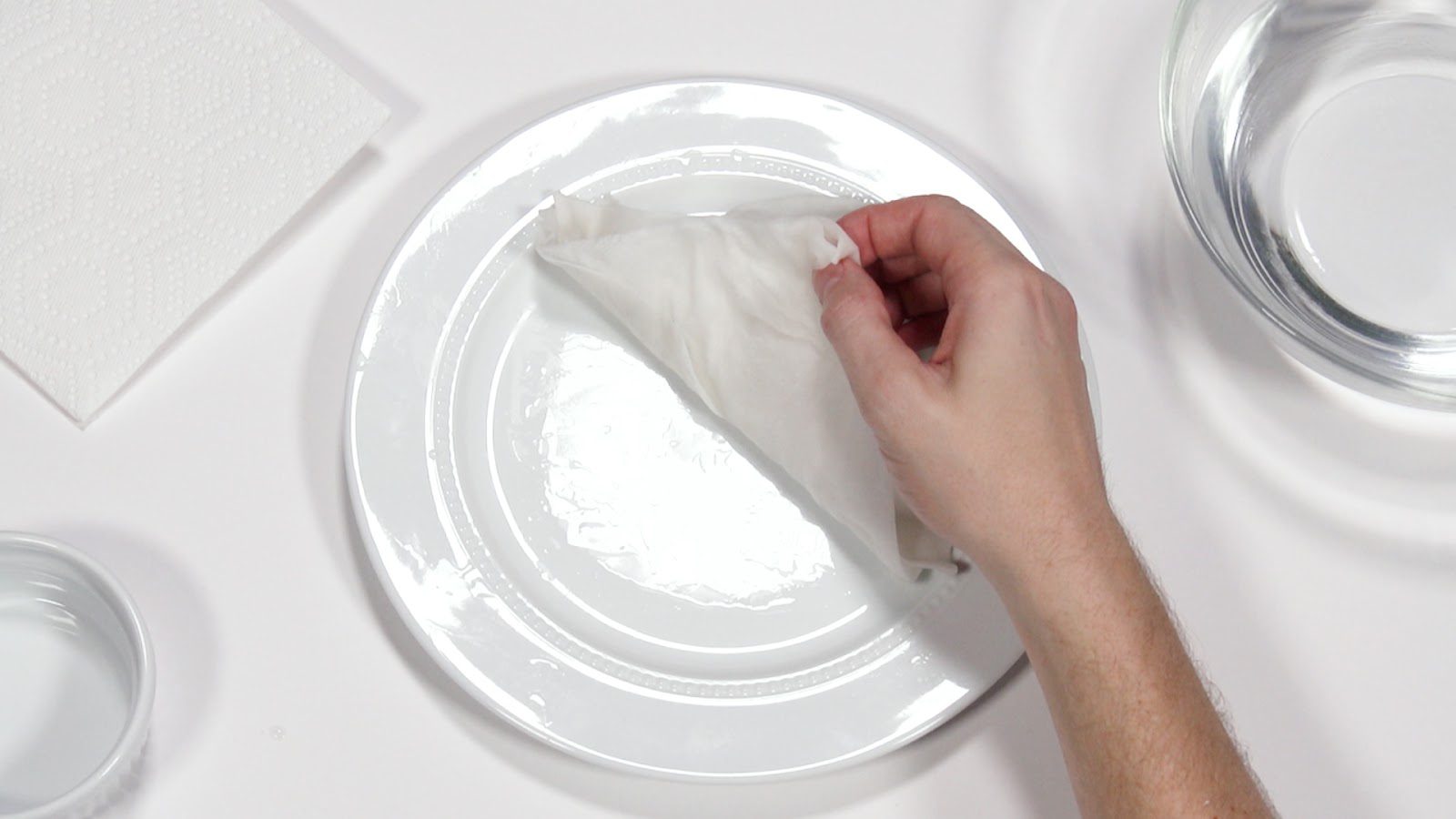 closeup hand folding a paper towel on a plate